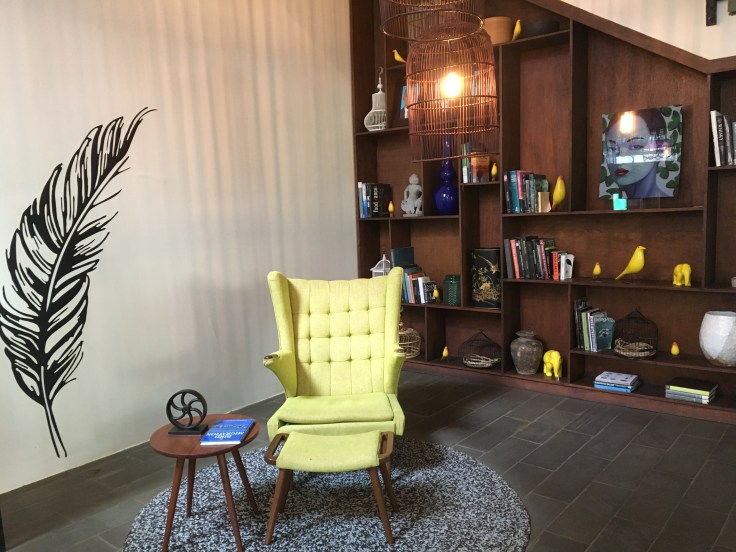 aviary hotel lobby easy chair and bookcase