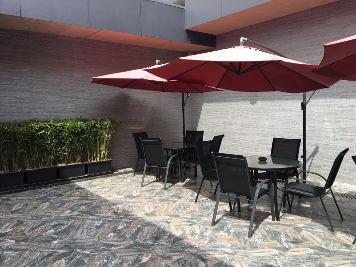 siem reap airport lounge outdoor patio umbrellas